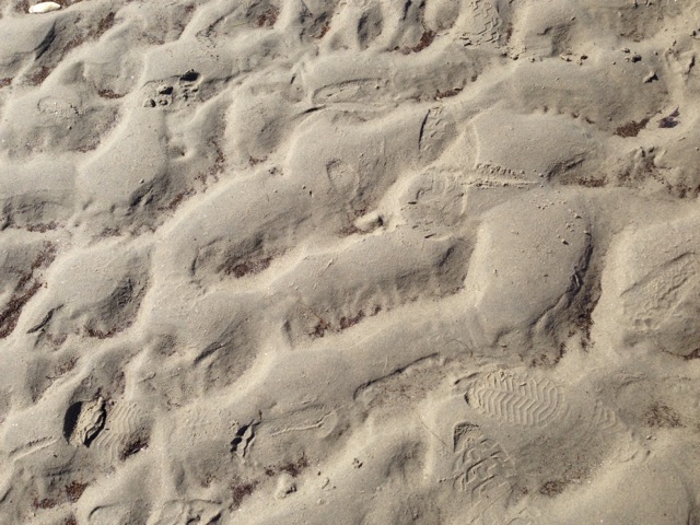 tide ripples and footsteps on the sand